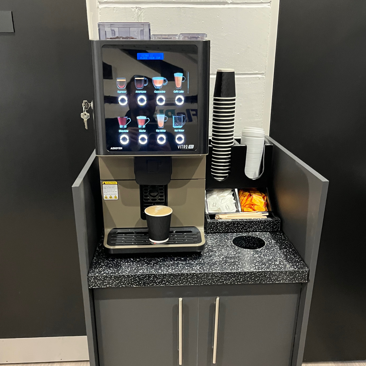 Commercial office coffee machine set up on a break room counter